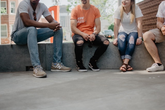 group of young people relaxing outside talking