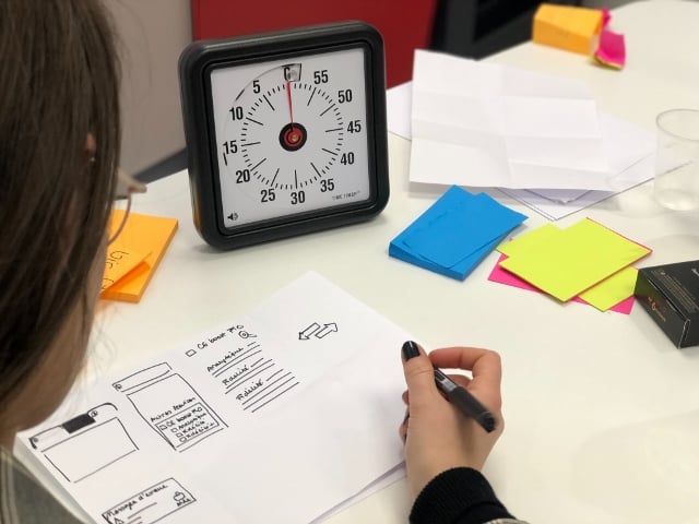 student writing an outline with a timer