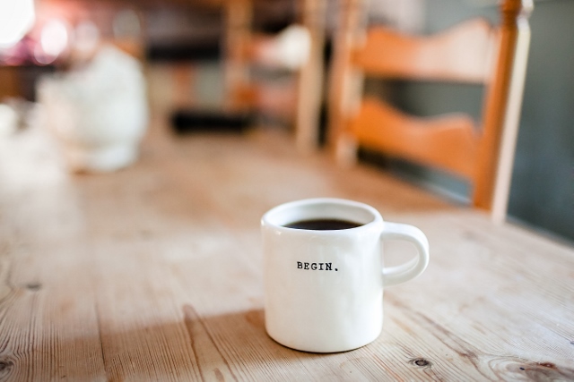 coffee cup printed with 'begin'