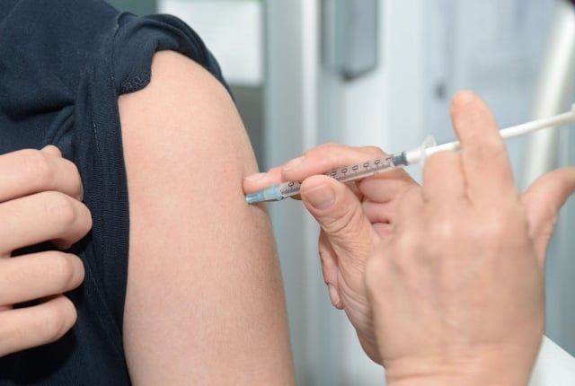 vaccine being injected into patient's arm