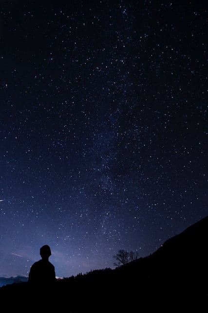 child looking up at night sky and stars