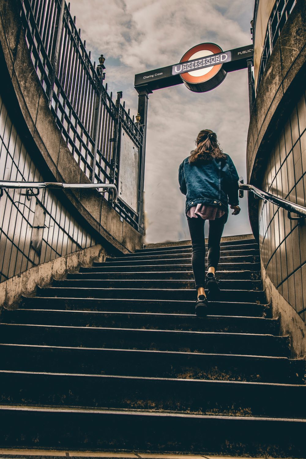 woman walking up concrete steps