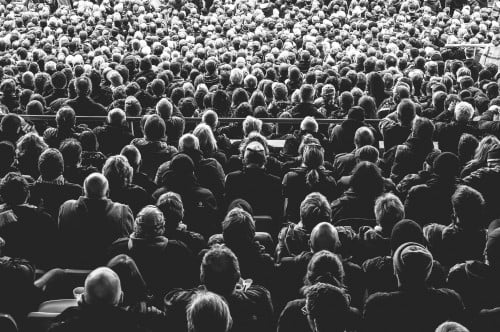 black-and-white photo of audience in lecture hall