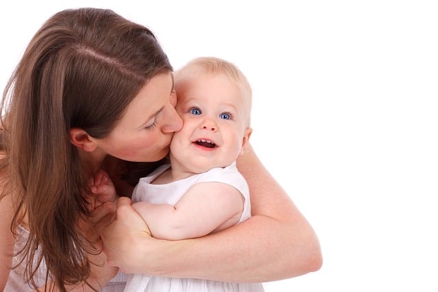 mother kissing her baby's cheek affectionately