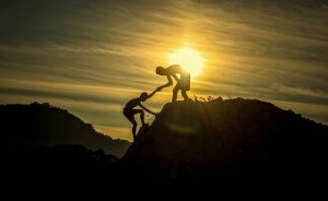 person helping another person climb