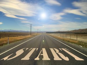 the word start painted on a road stretching into horizon