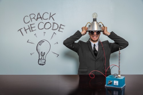 man wearing goofy contraption on head next to the words crack the code