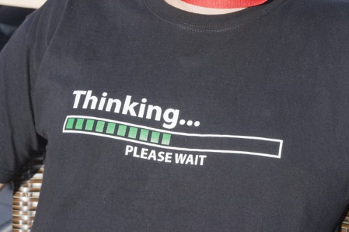 black t-shirt that says 'thinking...please wait' 