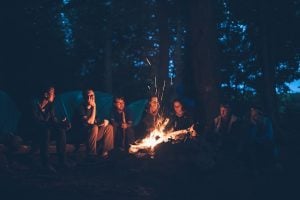 group telling stories around a campfire at the end of the night
