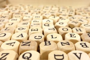 wooden game pieces printed with letters of the alphabet