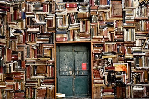 wall of school books surrounding blue double doors