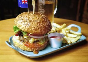 australian cheeseburger, fries, and beer