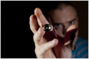 man lining up an accurate shot while throwing darts