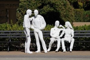 sculpture of a group of men and women discussing opposing viewpoints