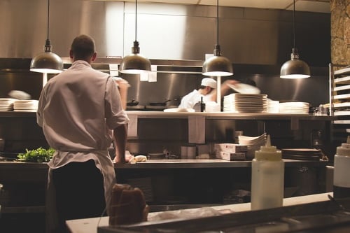 chef synthesizing dishes in a restaurant kitchen