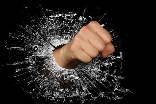 fist breaking through glass window