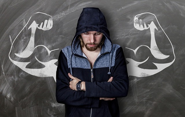 person lacking confidence standing in front of inspirational strength drawing