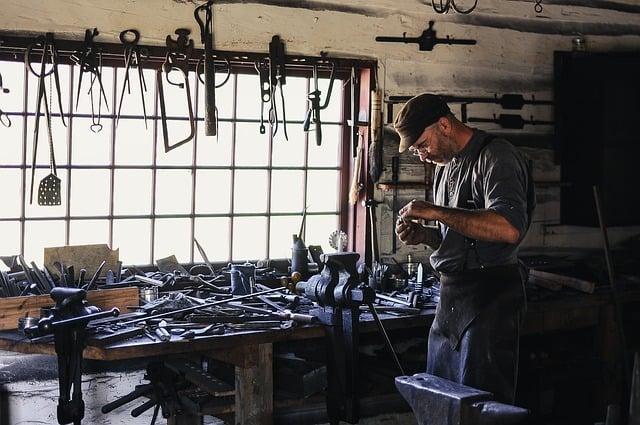 craftsman surrounded by tools in workshop