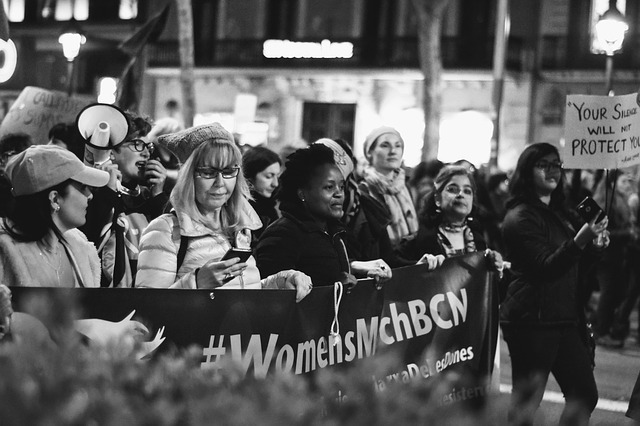 women carrying banner at women's march